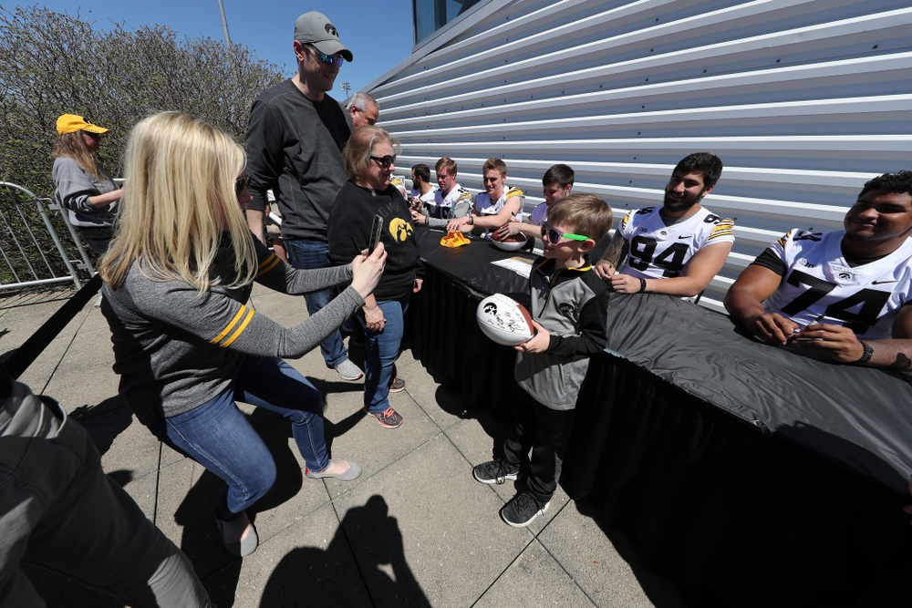 Members of the Iowa Football team sign autographs before the Iowa Hawkeyes game against the Nebraska Cornhuskers Saturday, April 20, 2019 at Duane Banks Field. (Brian Ray/hawkeyesports.com)