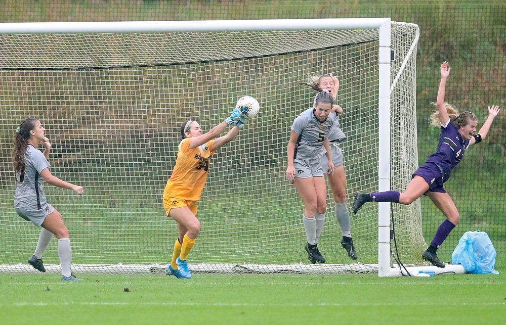 Iowa goalkeeper Claire Graves (34) gets her hands on a shot during the second half of their match at the Iowa Soccer Complex in Iowa City on Sunday, Sep 29, 2019. (Stephen Mally/hawkeyesports.com)