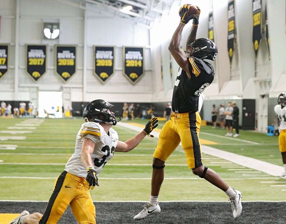 Iowa Hawkeyes wide receiver Calvin Lockett (right) pulls in a pass as defensive back Riley Moss (left) defends during Fall Camp Practice No. 6 at the Hansen Football Performance Center in Iowa City on Thursday, Aug 8, 2019. (Stephen Mally/hawkeyesports.com)