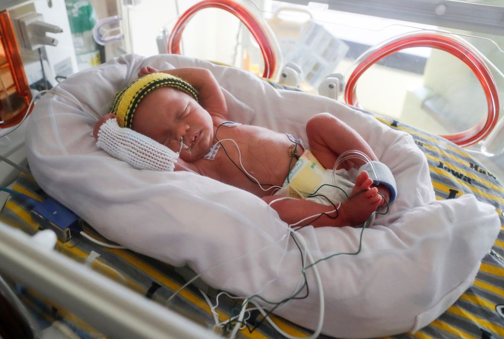 Iowa Hawkeyes offensive lineman Dalton Ferguson (76) and his girlfriend Rachael stand with their newborn twins Ella and Hazel Wednesday, September 12, 2018 in the NICU at the Stead Family Children's Hospital (Brian Ray/hawkeyesports.com)