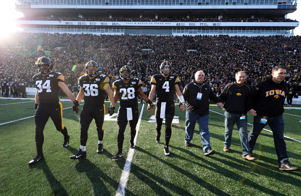 Iowa Hawkeyes captains linebacker Kristian Welch (34), fullback Brady Ross (36), running back Toren Young (28), and quarterback Nate Stanley (4) against the Minnesota Golden Gophers Saturday, November 16, 2019 at Kinnick Stadium. (Brian Ray/hawkeyesports.com)