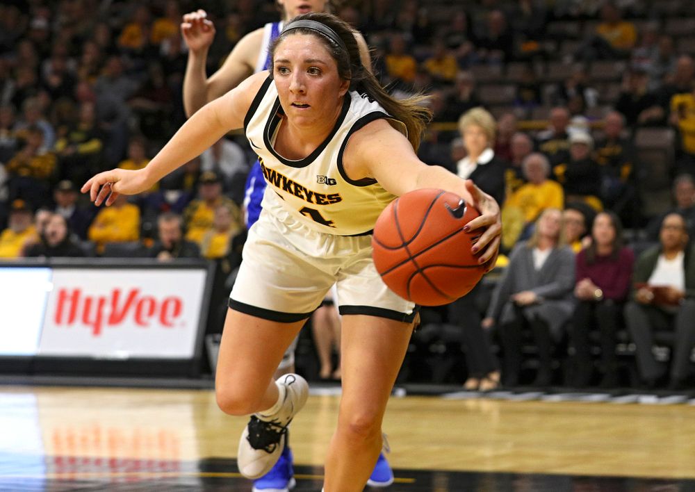 Iowa Hawkeyes guard Mckenna Warnock (14) saves a ball from going out of bounds during the fourth quarter of their game at Carver-Hawkeye Arena in Iowa City on Saturday, December 21, 2019. (Stephen Mally/hawkeyesports.com)