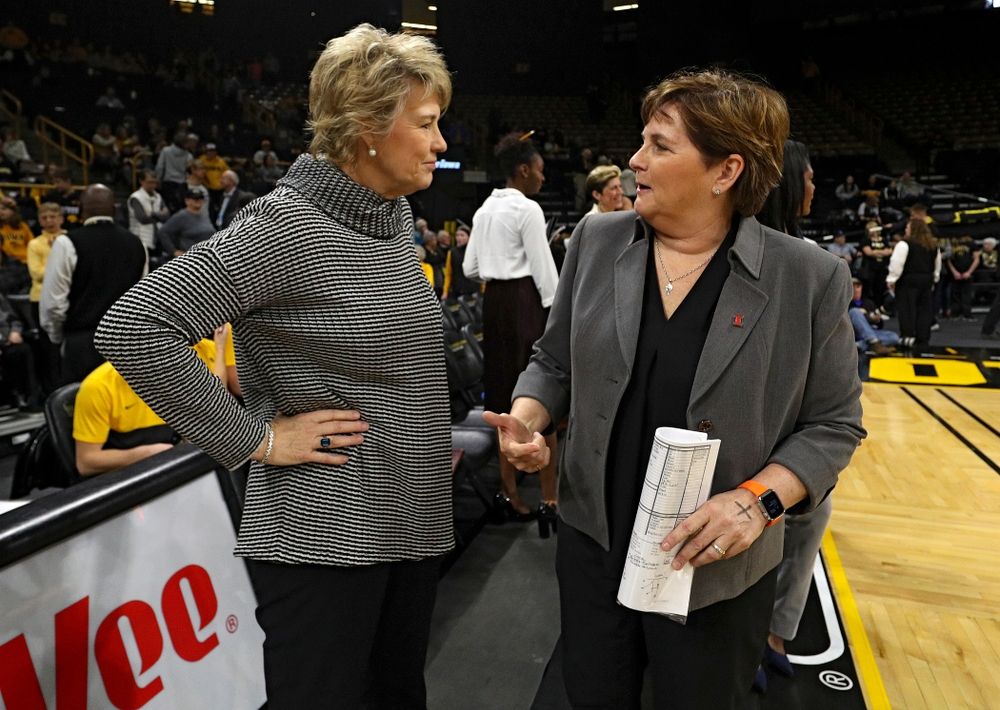 Iowa Hawkeyes head coach Lisa Bluder talks with Illinois Fighting Illini head coach Nancy Fahey before their game at Carver-Hawkeye Arena in Iowa City on Tuesday, December 31, 2019. (Stephen Mally/hawkeyesports.com)