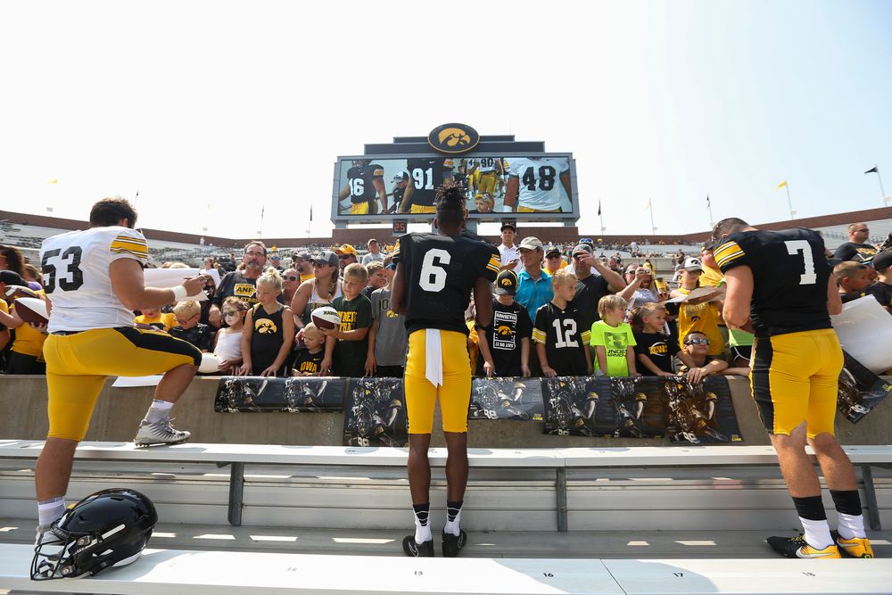 Iowa Hawkeyes defensive lineman Garret Jansen (53), Iowa Hawkeyes wide receiver Ihmir Smith-Marsette (6), Iowa Hawkeyes quarterback Spencer Petras