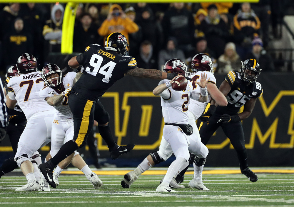 Iowa Hawkeyes defensive end A.J. Epenesa (94) strips the ball against the Minnesota Golden Gophers Saturday, November 16, 2019 at Kinnick Stadium. (Brian Ray/hawkeyesports.com)