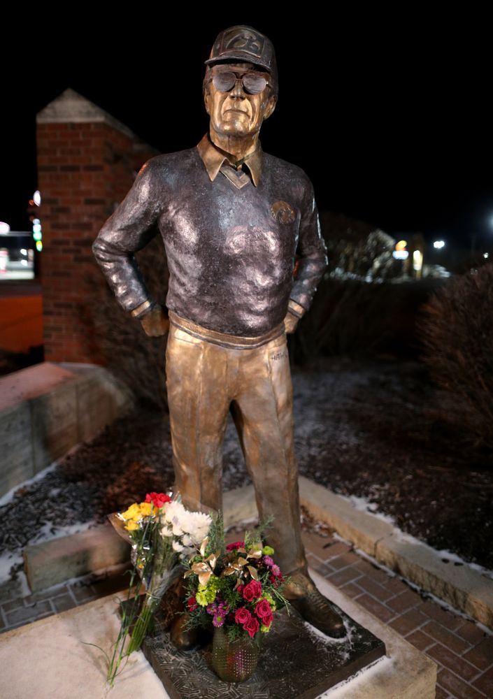 Mourners lay flowers at the statue of former Hawkeye Football Head Coach Hayden Fry Tuesday, December 17, 2019 in Coralville. Fry passed away on Tuesday at the age of 90. (Brian Ray/hawkeyesports.com)