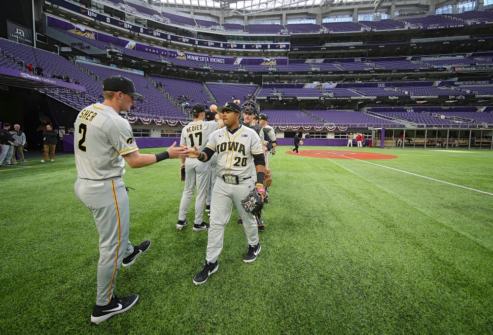 Iowa Hawkeyes infielder Brendan Sher (2) and infielder Izaya Fullard (20) greet each other after warming up before their CambriaCollegeClassic game at U.S. Bank Stadium in Minneapolis, Minn. on Friday, February 28, 2020. (Stephen Mally/hawkeyesports.com)