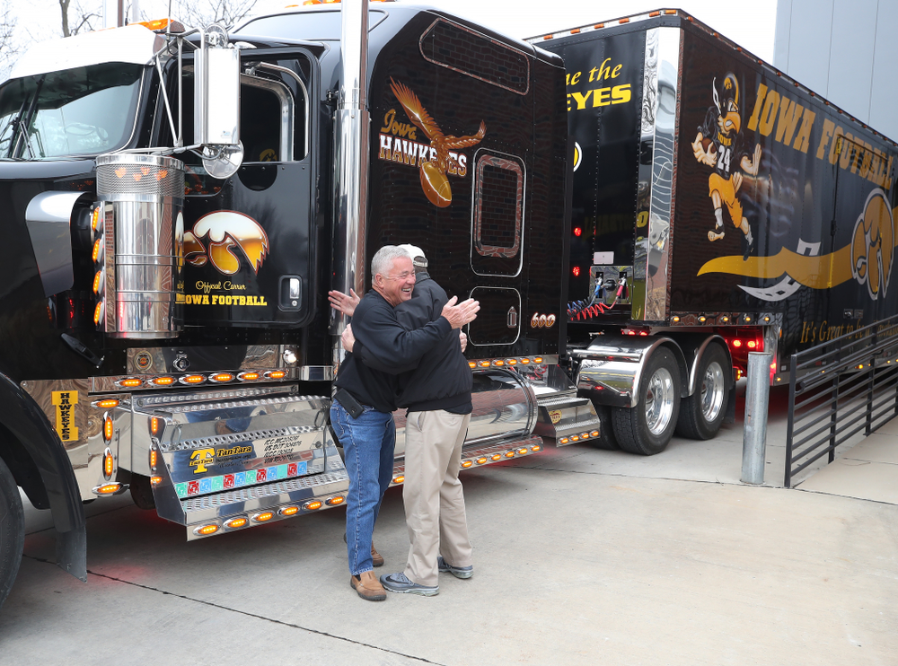 TanTara Transportation Corporation President Mike Riggan hugs head football equipment manager Greg Morris before departing for Tampa Florida Friday, December 21, 2018 at the Hansen Football Performance Center. (Brian Ray/hawkeyesports.com)