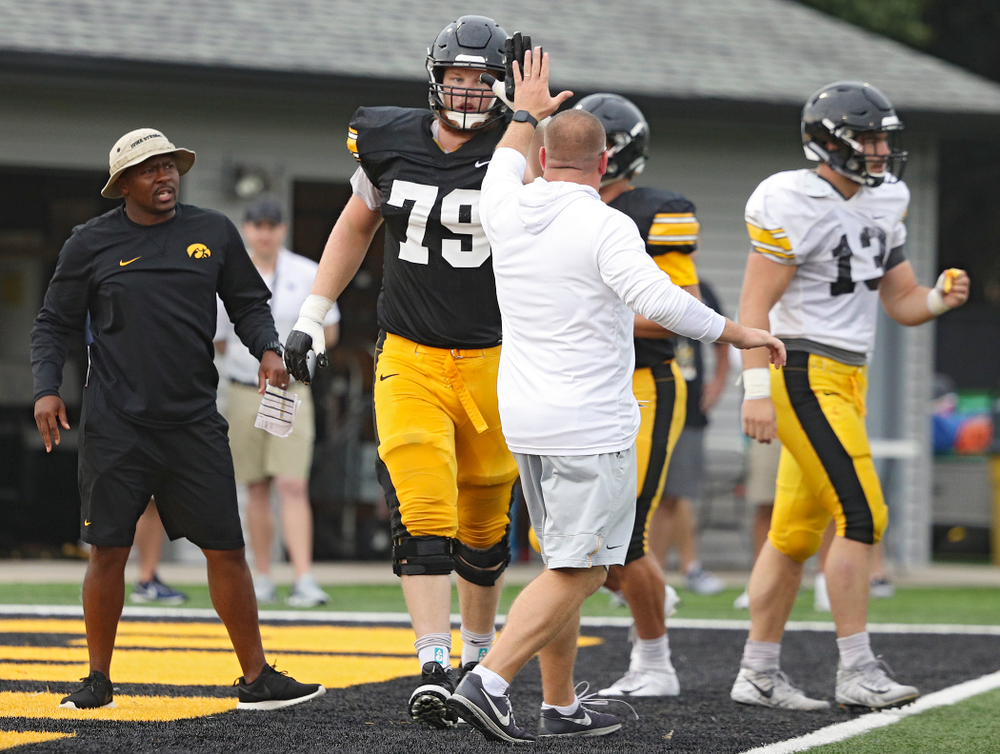 Iowa Hawkeyes offensive lineman Jack Plumb (79) gets a high-five from offensive line coach Tim Polasek durning Fall Camp Practice No. 17 at the Hansen Football Performance Center in Iowa City on Wednesday, Aug 21, 2019. (Stephen Mally/hawkeyesports.com)