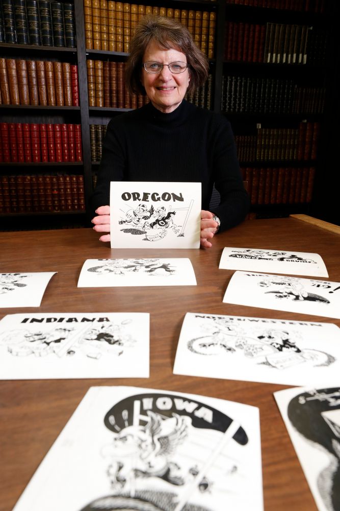 Jane Roth sits with some of the original drawings of Herky the Hawk Friday, April 20, 2018 at the University of Iowa Library. Roth has donated the drawings, which were created by artist Dick Spencer, to the library's special collection. (Brian Ray/hawkeyesports.com)