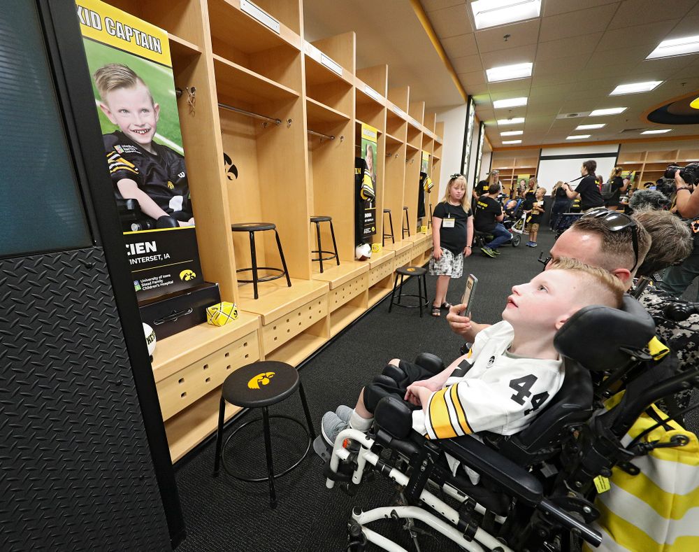 Kid Captain Cien Currie looks at his locker in the Iowa locker room during Kids Day at Kinnick Stadium in Iowa City on Saturday, Aug 10, 2019. (Stephen Mally/hawkeyesports.com)