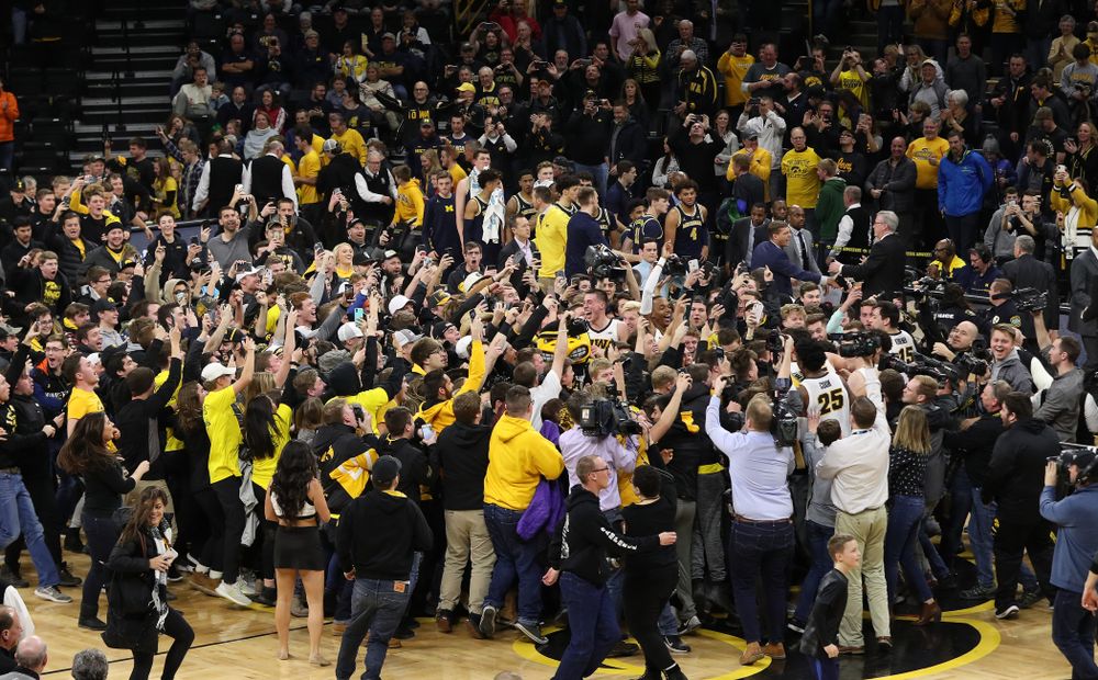 Fans storm the court after Iowa Hawkeyes defeated the Michigan Wolverines Friday, February 1, 2019 at Carver-Hawkeye Arena. (Brian Ray/hawkeyesports.com)