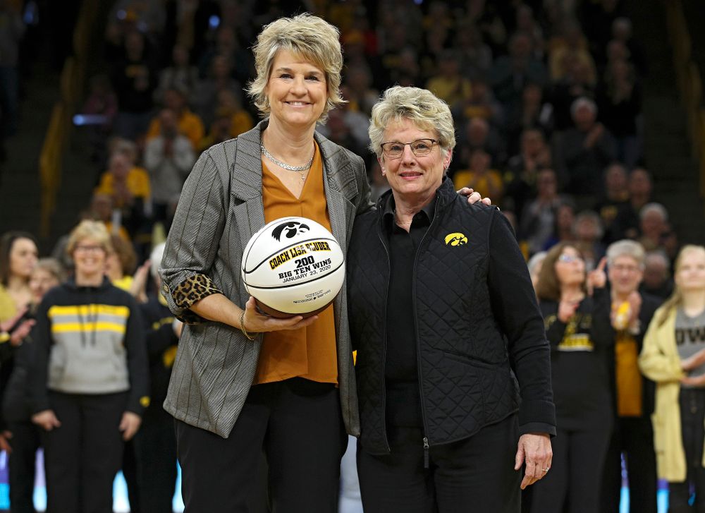 Iowa Hawkeyes head coach Lisa Bluder is recognized for her 200th Big Ten win with Barbara Burke, Deputy Director of Athletics and Senior Woman Administrator, before the game at Carver-Hawkeye Arena in Iowa City on Thursday, February 6, 2020. (Stephen Mally/hawkeyesports.com)