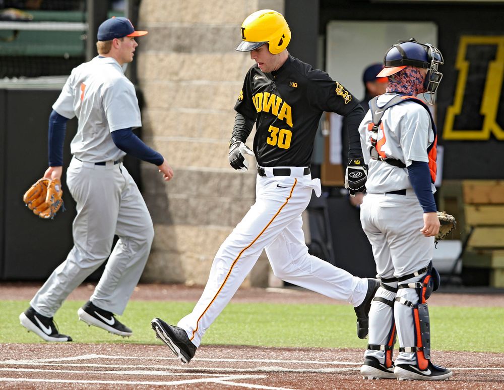 Iowa Hawkeyes left fielder Connor McCaffery (30) scores a run during the second inning of their game against Illinois at Duane Banks Field in Iowa City on Saturday, Mar. 30, 2019. (Stephen Mally/hawkeyesports.com)