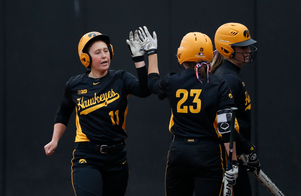 Iowa Hawkeyes first baseman Mallory Kilian (11) and infielder Alex Rath (23) against the Minnesota Golden Gophers Friday, April 13, 2018 at Bob Pearl Field. (Brian Ray/hawkeyesports.com)