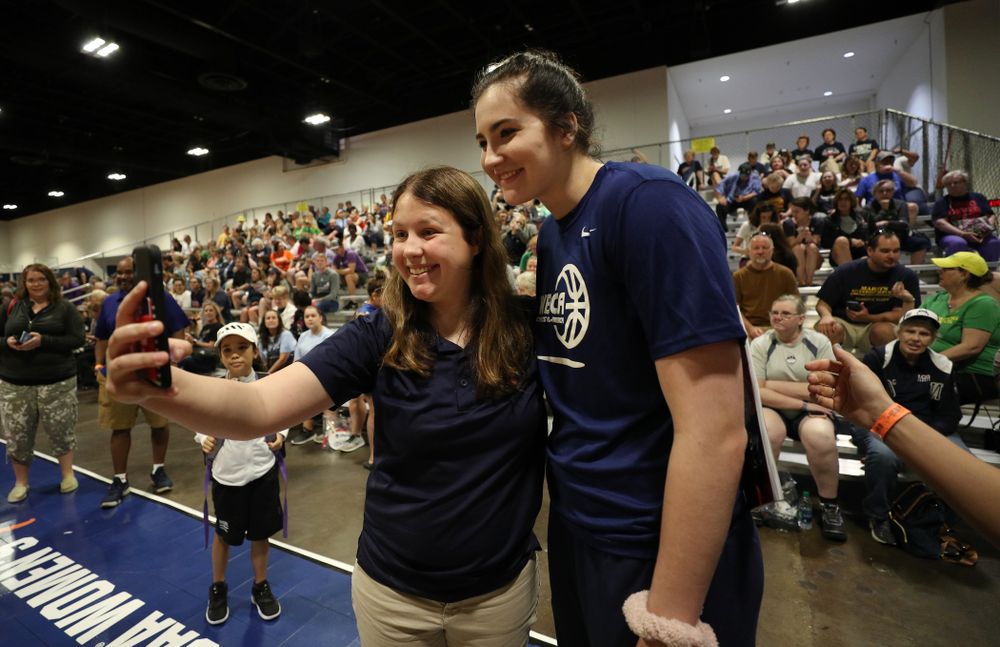 Iowa Hawkeyes forward Megan Gustafson (10) takes photos with a fan at the Tourney Town Fan Fest Friday, April 5, 2019 at the Tampa Convention Center in Tampa, FL. (Brian Ray/hawkeyesports.com)