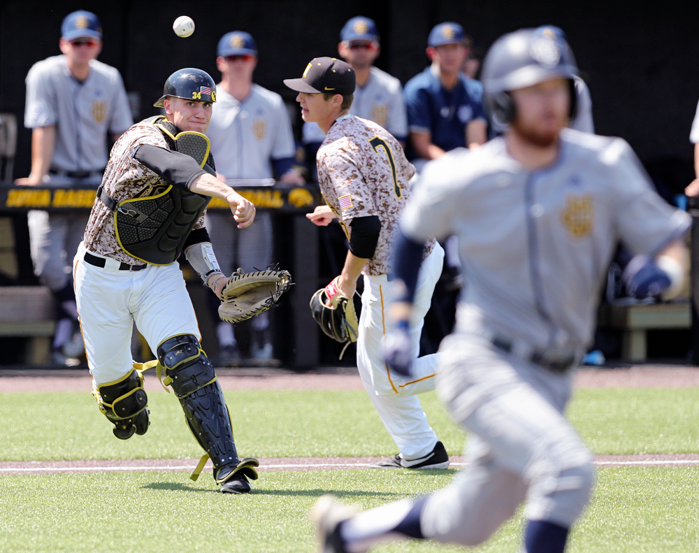 Iowa Hawkeyes catcher Austin Martin (34) throws to first for an out after fielding a bunt during the third inning of their game against UC Irvine at Duane Banks Field in Iowa City on Sunday, May. 5, 2019. (Stephen Mally/hawkeyesports.com)