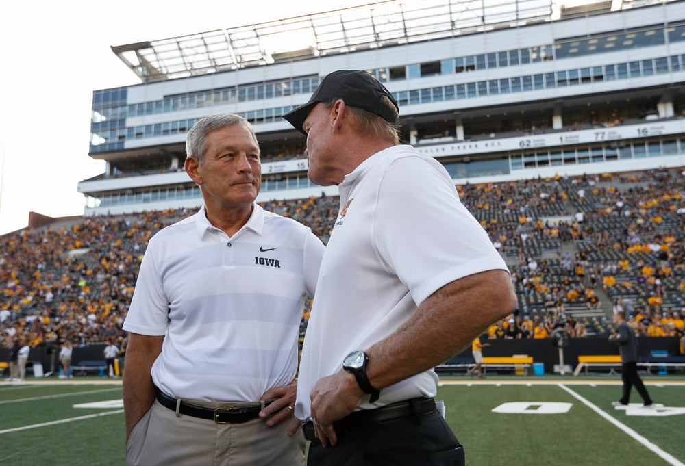 Iowa Hawkeyes head coach Kirk Ferentz and Northern Iowa head coach Mark Farley talk before a game against Northern Iowa at Kinnick Stadium on September 15, 2018. (Tork Mason/hawkeyesports.com)