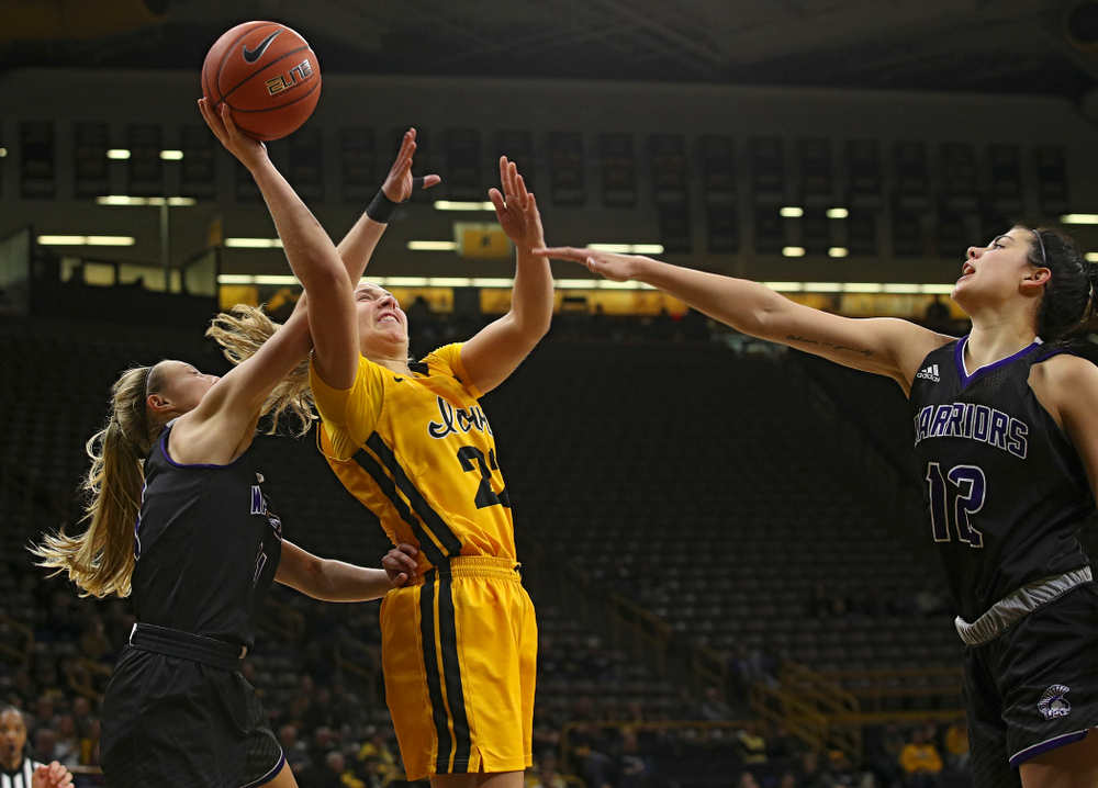 Iowa guard Kathleen Doyle (22) shoots between two defenders during the third quarter of their game against Winona State at Carver-Hawkeye Arena in Iowa City on Sunday, Nov 3, 2019. (Stephen Mally/hawkeyesports.com)