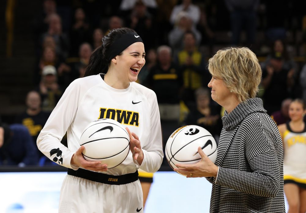 Iowa Hawkeyes forward Megan Gustafson (10) receives a pair of commemorative basketballs from head coach Lisa Bluder for becoming the school's all time rebounds leader and scoring leader before their gam eagainst the Nebraska Cornhuskers Thursday, January 3, 2019 at Carver-Hawkeye Arena. (Brian Ray/hawkeyesports.com)