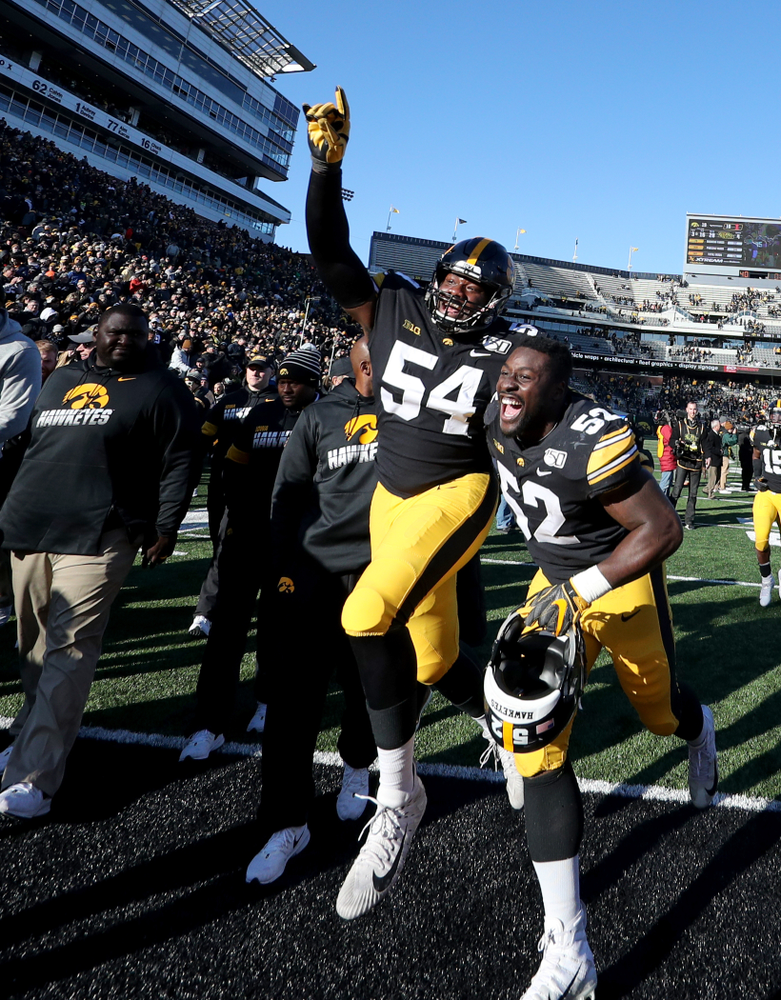 Iowa Hawkeyes defensive tackle Daviyon Nixon (54) and linebacker Amani Jones (52) against the Illinois Fighting Illini Saturday, November 23, 2019 at Kinnick Stadium. (Brian Ray/hawkeyesports.com)