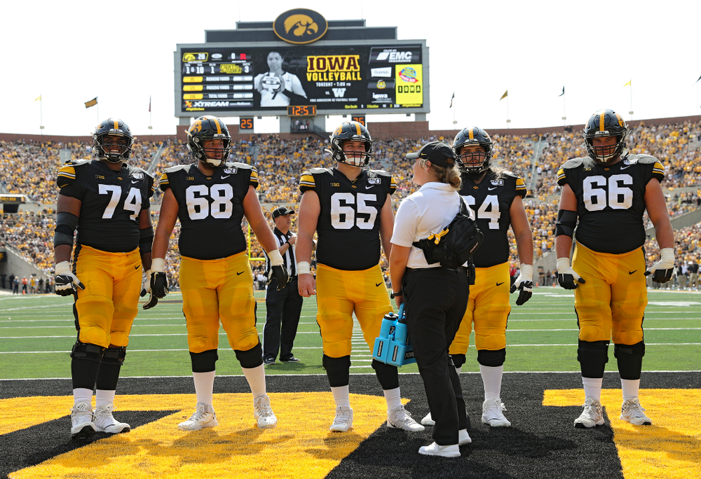 Iowa Hawkeyes offensive lineman Tristan Wirfs (74), offensive lineman Landan Paulsen (68), offensive lineman Tyler Linderbaum (65), offensive lineman Kyler Schott (64), and offensive lineman Levi Paulsen (66) on the field during a TV timeout during the third quarter of their Big Ten Conference football game at Kinnick Stadium in Iowa City on Saturday, Sep 7, 2019. (Stephen Mally/hawkeyesports.com)