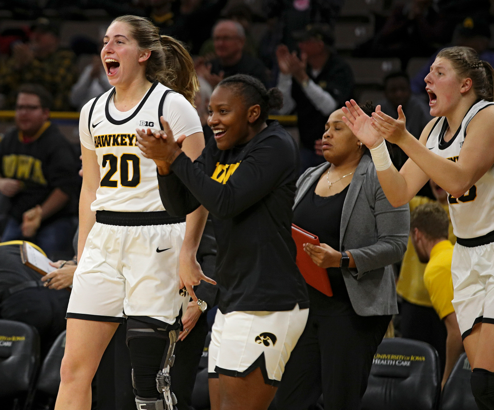 Iowa guard Kate Martin (20), guard Zion Sanders (21), and forward/center Monika Czinano (25) celebrate during the third quarter of their overtime win against Princeton at Carver-Hawkeye Arena in Iowa City on Wednesday, Nov 20, 2019. (Stephen Mally/hawkeyesports.com)