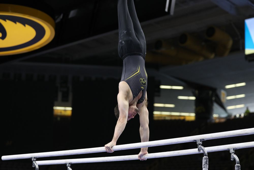 Iowa's Rogelio Vazquez competes on the parallel bars against the Ohio State Buckeyes Saturday, March 16, 2019 at Carver-Hawkeye Arena. (Brian Ray/hawkeyesports.com)