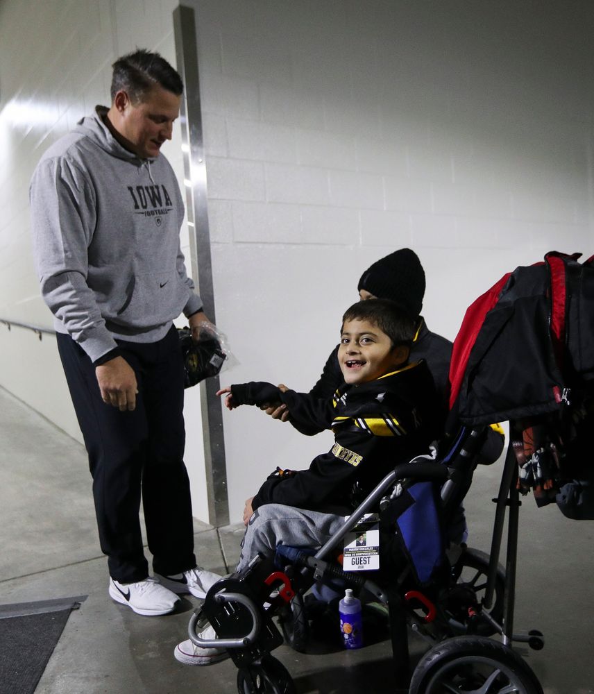 Iowa Hawkeyes offensive coordinator Brian Ferentz meets with Kid Captain Mason Gonzalez before a game against Northwestern at Kinnick Stadium on November 10, 2018. (Tork Mason/hawkeyesports.com)