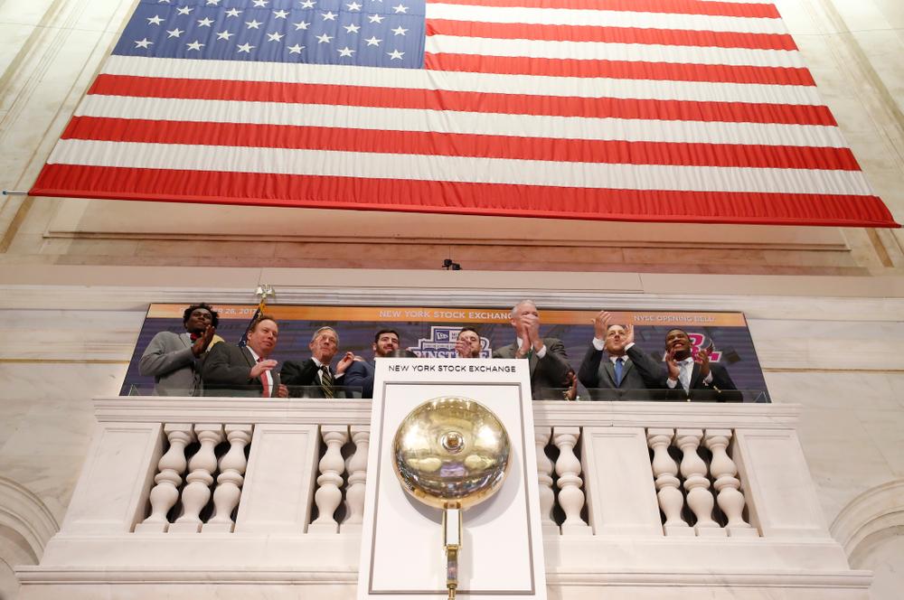 Iowa Hawkeyes linebacker Josey Jewell (43), defensive back Joshua Jackson (15), offensive lineman Sean Welsh (79) and head coach Kirk Ferentz ring the opening bell at the New York Stock Exchange Tuesday, December 26, 2017 in New York. (Brian Ray/hawkeyesports.com)