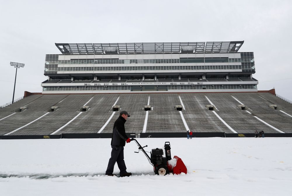 Members of the Iowa Athletics Turf Management staff create the #SnowWave for kids in the Stead Family Children's Hospital Thursday, February