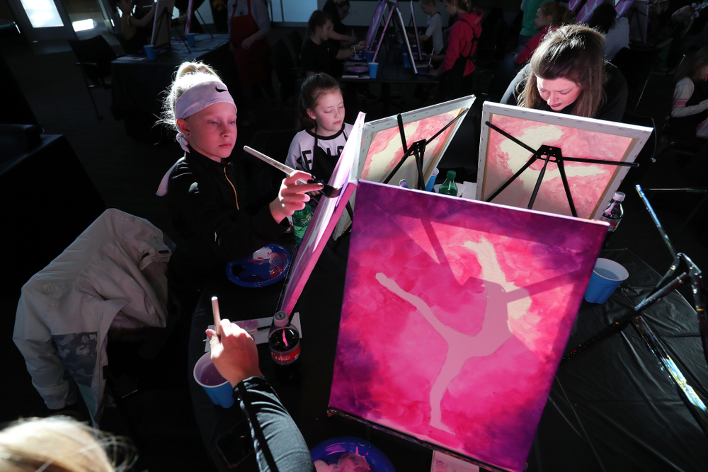 Fans of the GymHawks paint a gymnast with Brush and Barrel before the Iowa Hawkeyes meet against the Minnesota Golden Gophers Saturday, January 19, 2019 at Carver-Hawkeye Arena. (Brian Ray/hawkeyesports.com)