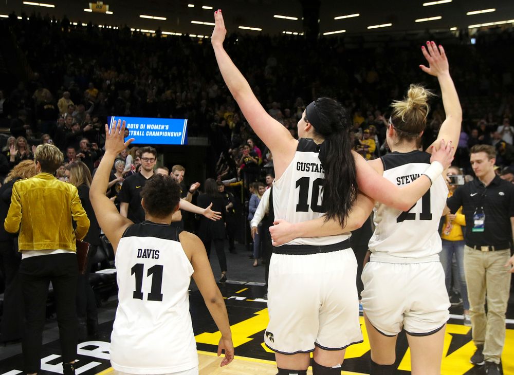 Iowa Hawkeyes guard Tania Davis (11), center Megan Gustafson (10), and forward Hannah Stewart (21) wave to the crowd after winning their second round game in the 2019 NCAA Women's Basketball Tournament at Carver Hawkeye Arena in Iowa City on Sunday, Mar. 24, 2019. (Stephen Mally for hawkeyesports.com)