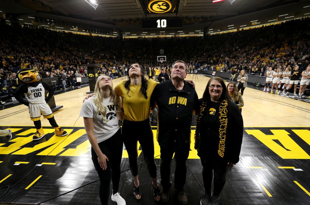 Megan Gustafson stands with her family as her number is raised into the rafters during a jersey retirement ceremony Sunday, January 26, 2020 at Carver-Hawkeye Arena. (Brian Ray/hawkeyesports.com)