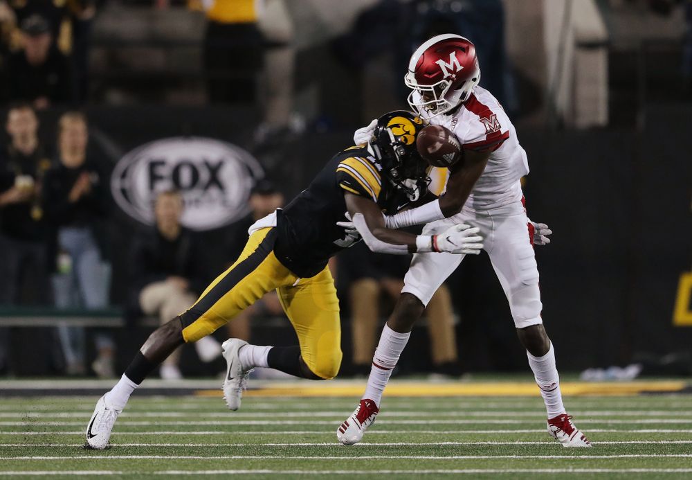 Iowa Hawkeyes defensive back Michael Ojemudia (11) breaks up a pass against the Miami RedHawks Saturday, August 31, 2019 at Kinnick Stadium in Iowa City. (Brian Ray/hawkeyesports.com)
