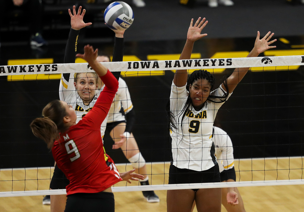 Iowa Hawkeyes right side hitter Reghan Coyle (8) and Iowa Hawkeyes middle blocker Amiya Jones (9) go up for a block during a match against Maryland at Carver-Hawkeye Arena on November 23, 2018. (Tork Mason/hawkeyesports.com)
