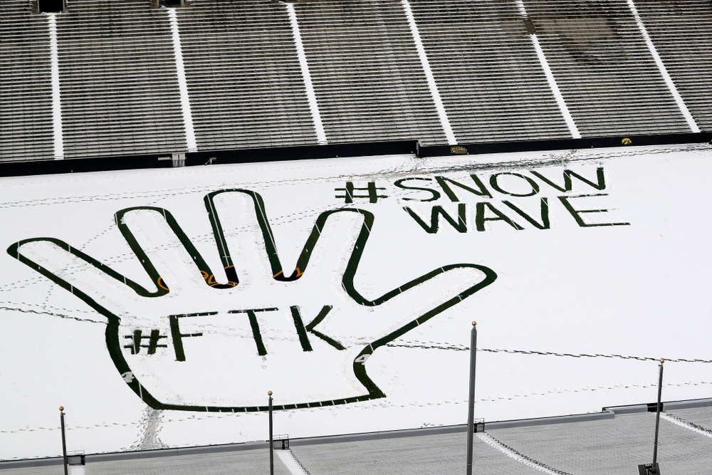 Members of the Iowa Athletics Turf Management staff create the #SnowWave for kids in the Stead Family Children's Hospital Thursday, February
