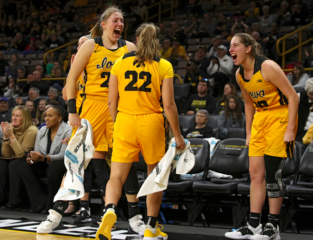 Iowa forward/center Monika Czinano (25), guard Kathleen Doyle (22), and guard Kate Martin (20) celebrate on the bench during the fourth quarter of their game against Winona State at Carver-Hawkeye Arena in Iowa City on Sunday, Nov 3, 2019. (Stephen Mally/hawkeyesports.com)