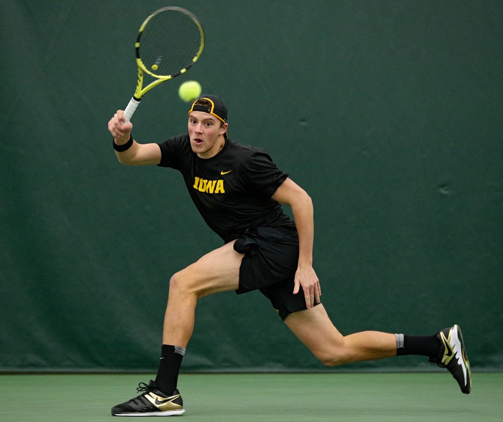 Iowa’s Joe Tyler returns a shot during their match at the Hawkeye Tennis and Recreation Complex in Iowa City on Thursday, January 16, 2020. (Stephen Mally/hawkeyesports.com)