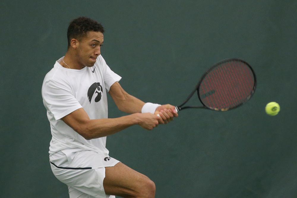 Iowa’s Oliver Okonkwo returns a hit during the Iowa men’s tennis meet vs Nebraska on Sunday, March 1, 2020 at the Hawkeye Tennis and Recreation Complex. (Lily Smith/hawkeyesports.com)