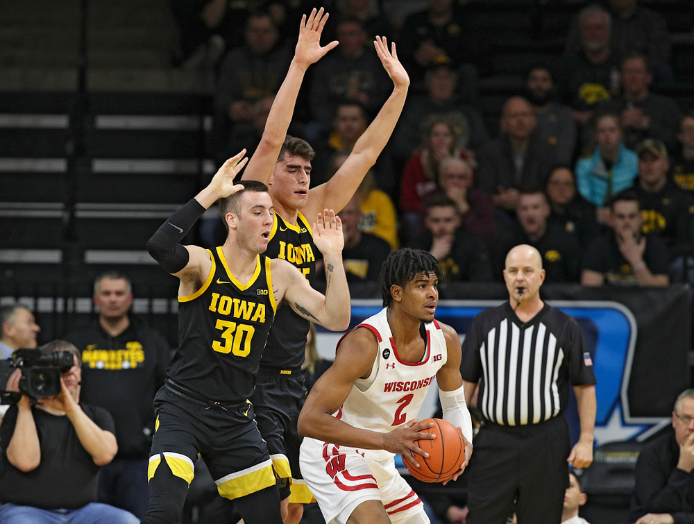 Iowa Hawkeyes guard Connor McCaffery (30) and center Luka Garza (55) pressure Wisconsin Badgers forward Aleem Ford (2) during the first half of their game at Carver-Hawkeye Arena in Iowa City on Monday, January 27, 2020. (Stephen Mally/hawkeyesports.com)