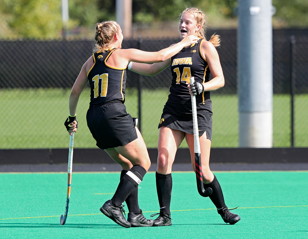 Iowa’s Lokke Stribos (14) celebrates with Katie Birch (11) after Stribos scored a goal during the first quarter of their match at Grant Field in Iowa City on Friday, Oct 4, 2019. (Stephen Mally/hawkeyesports.com)
