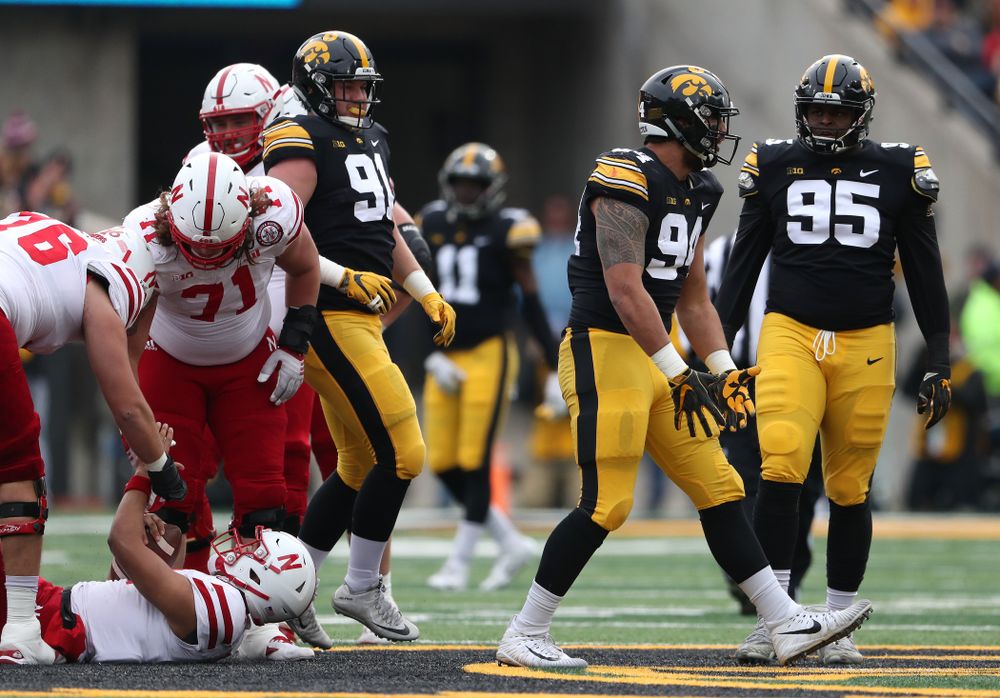 Iowa Hawkeyes defensive end A.J. Epenesa (94) sacks Nebraska Cornhuskers quarterback Adrian Martinez (2) Friday, November 23, 2018 at Kinnick Stadium. (Brian Ray/hawkeyesports.com)
