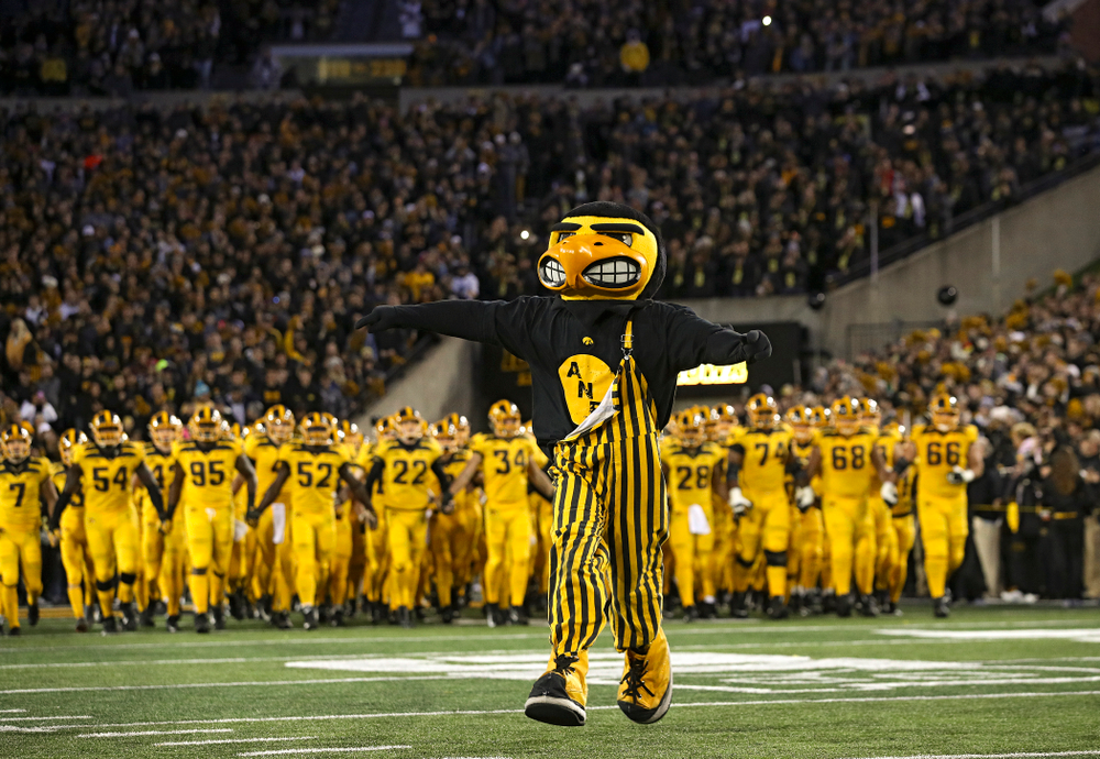 Herky leads the Hawkeyes as they swarm to take the field before their game at Kinnick Stadium in Iowa City on Saturday, Oct 12, 2019. (Stephen Mally/hawkeyesports.com)