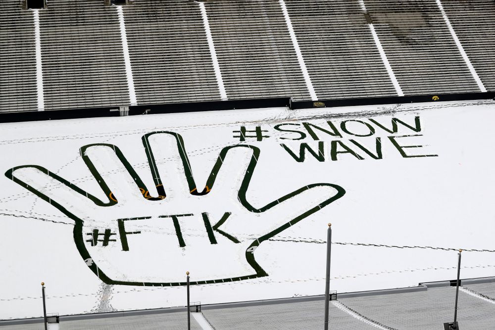 Members of the Iowa Athletics Turf Management staff create the #SnowWave for kids in the Stead Family Children's Hospital Thursday, February