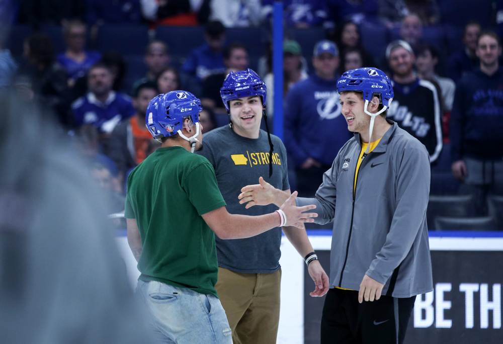 Iowa Hawkeyes tight end T.J. Hockenson (38), quarterback Nate Stanley (4), and defensive back Amani Hooker (27) following an on ice contest against Mississippi State during the first intermission of the Tampa Bay Lightning game Thursday, December 27, 2018 at Amalie Arena. (Brian Ray/hawkeyesports.com)