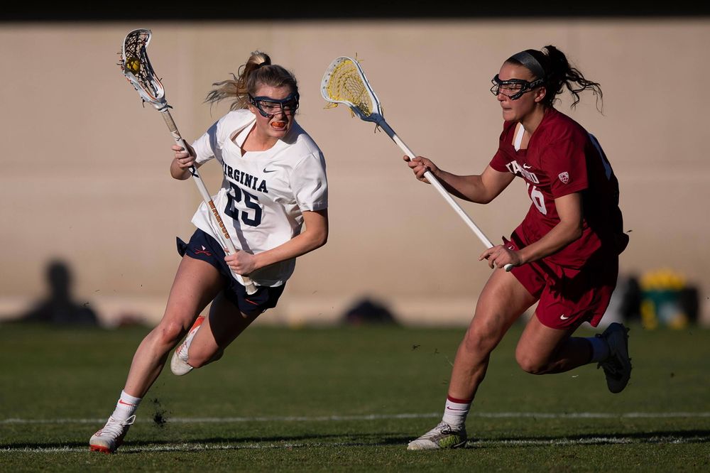 STANFORD, California - FEBRUARY 14: Virginia Cavaliers midfield Courtlynne Caskin (25) is defended by Stanford Cardinal midfield Chelsea Trattner (16) during the second half at Cagan Stadium on February 14, 2020 in Stanford, California. The Virginia Cavaliers defeated the Stanford Cardinal 12-11. (Photo by Jason O. Watson)