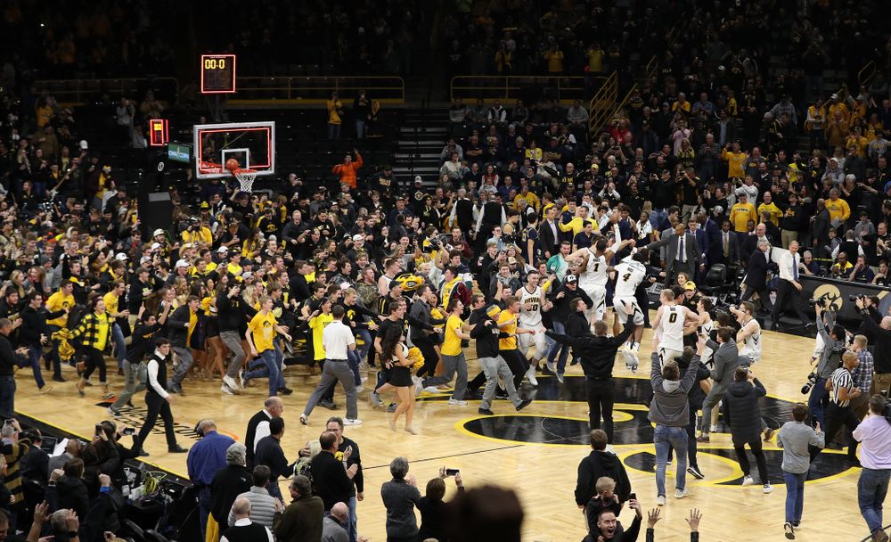 Fans storm the court after Iowa Hawkeyes defeated the Michigan Wolverines Friday, February 1, 2019 at Carver-Hawkeye Arena. (Brian Ray/hawkeyesports.com)
