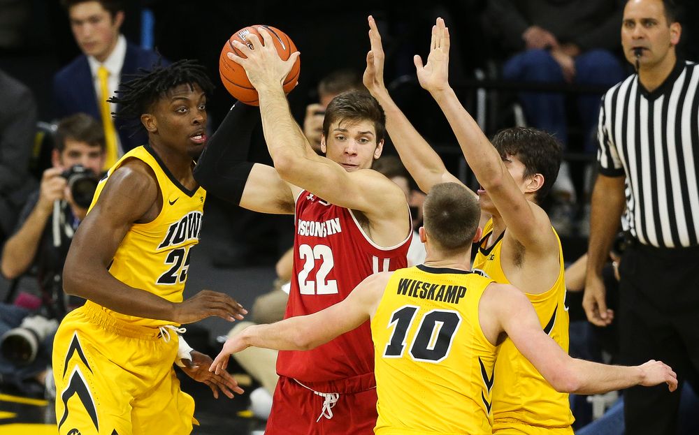 Iowa Hawkeyes forward Tyler Cook (25), Iowa Hawkeyes guard Joe Wieskamp (10) and Iowa Hawkeyes forward Luka Garza (55) trap Wisconsin's Ethan Happ on November 30, 2018 at Carver-Hawkeye Arena. (Tork Mason/hawkeyesports.com)