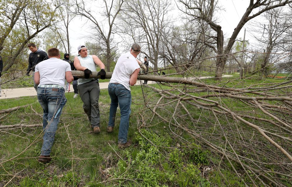 Members of the Hawkeye Football team volunteer with the Iowa City Public Works department along the Iowa River during the annual Iowa Athletics Day of Caring Sunday, April 28, 2019 in Iowa City. (Brian Ray/hawkeyesports.com)
